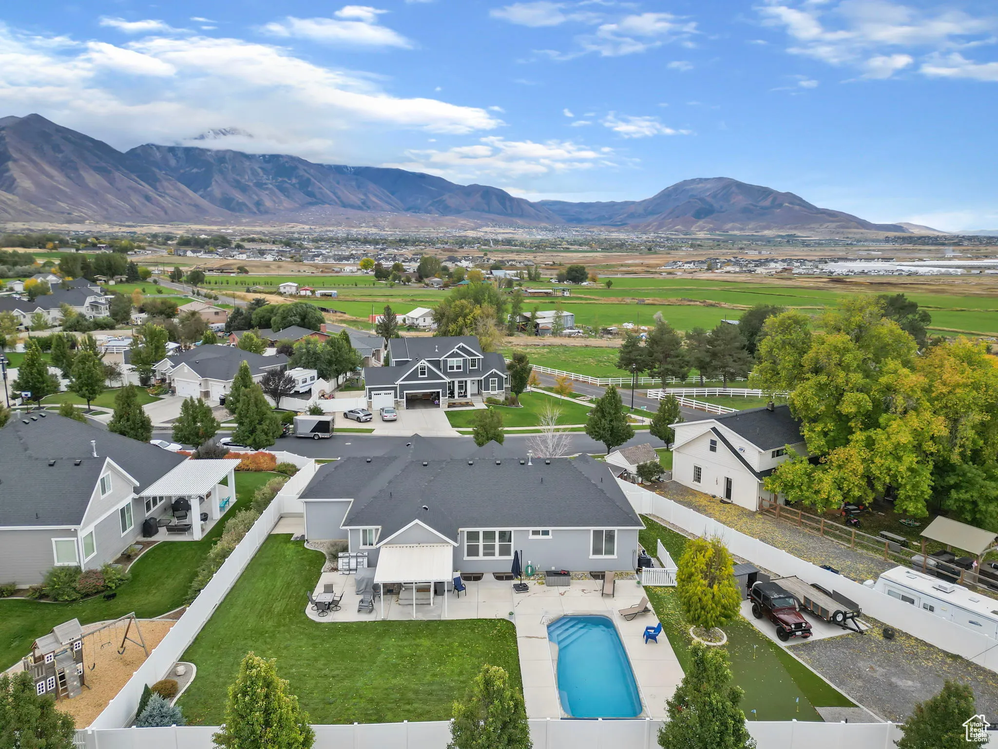 Aerial view of residential area featuring mountains and a pool area