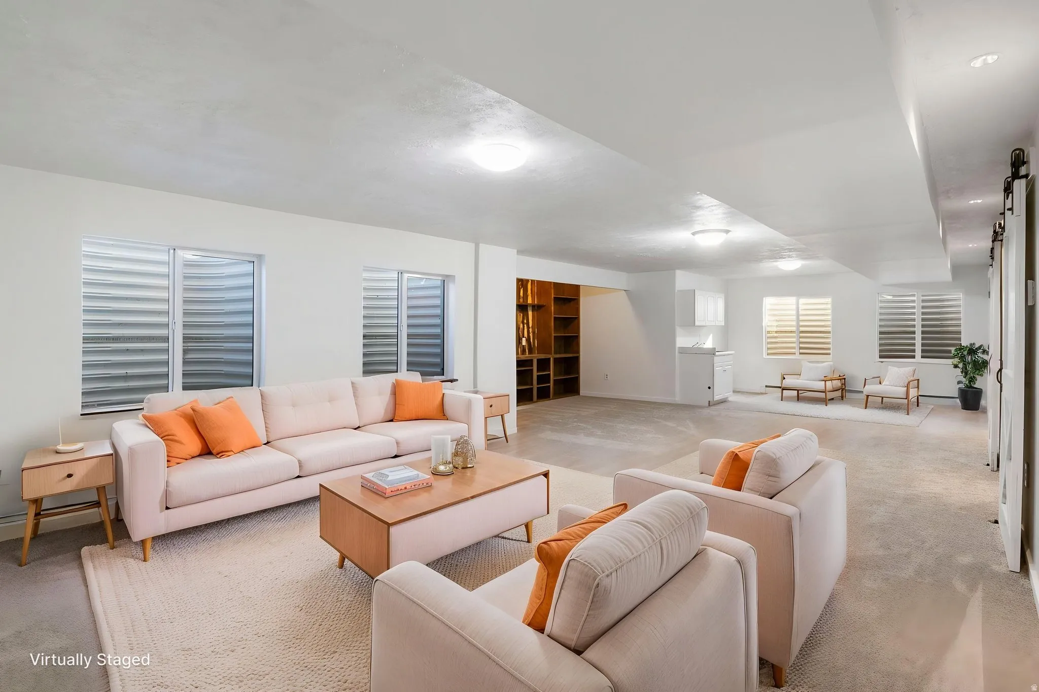 Carpeted living area featuring baseboards