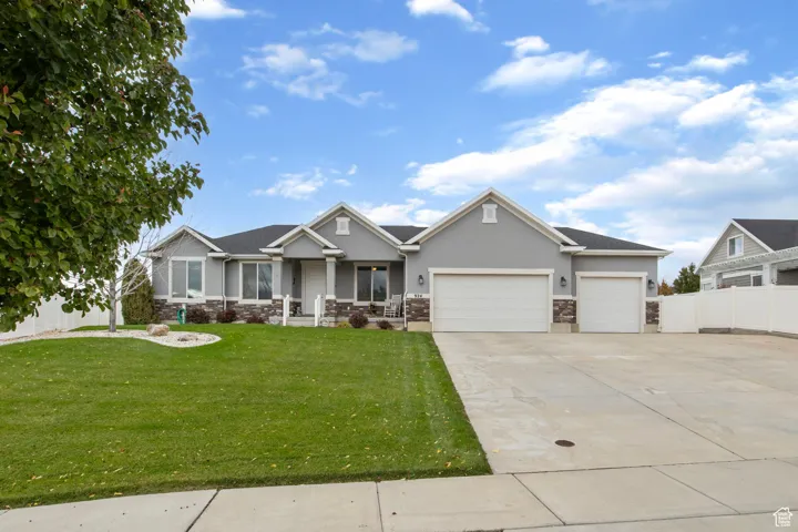 Craftsman inspired home with stone siding, stucco siding, driveway, and a porch
