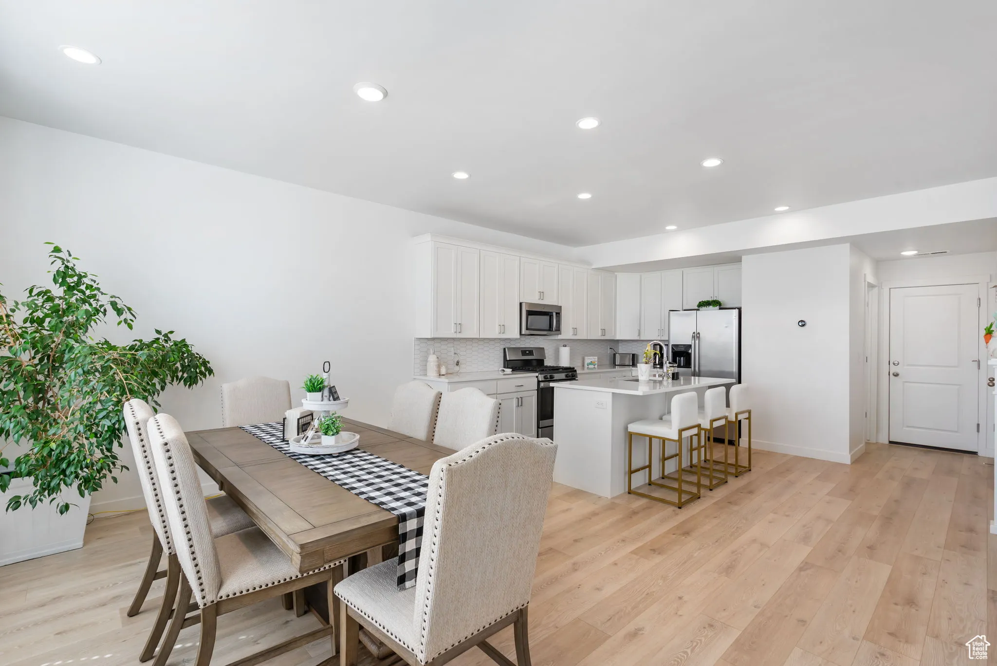 Dining space with recessed lighting and light wood-style flooring