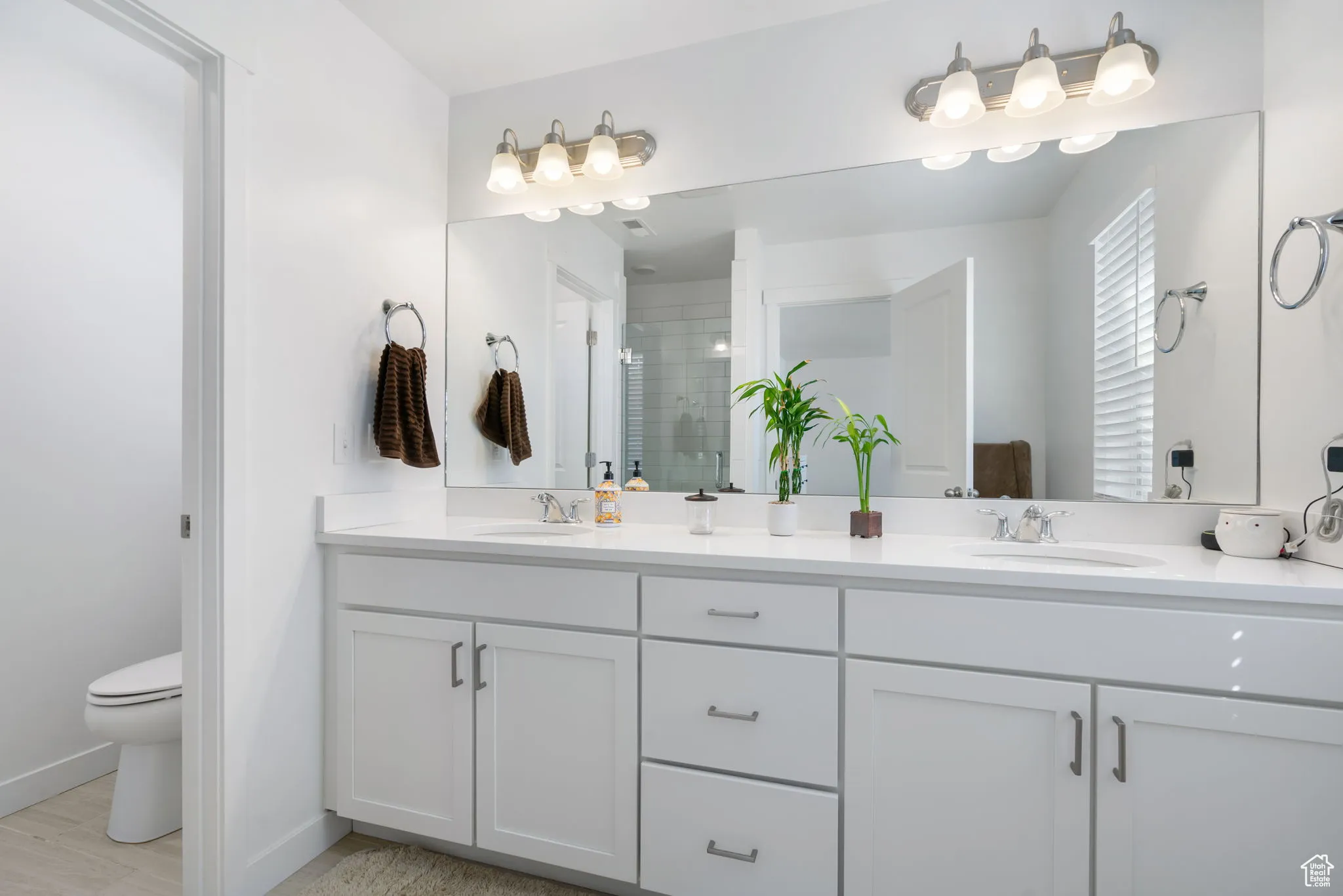 Bathroom with a shower stall and double vanity