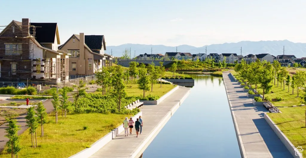 View of property's community with a residential view, a lawn, and a mountain view