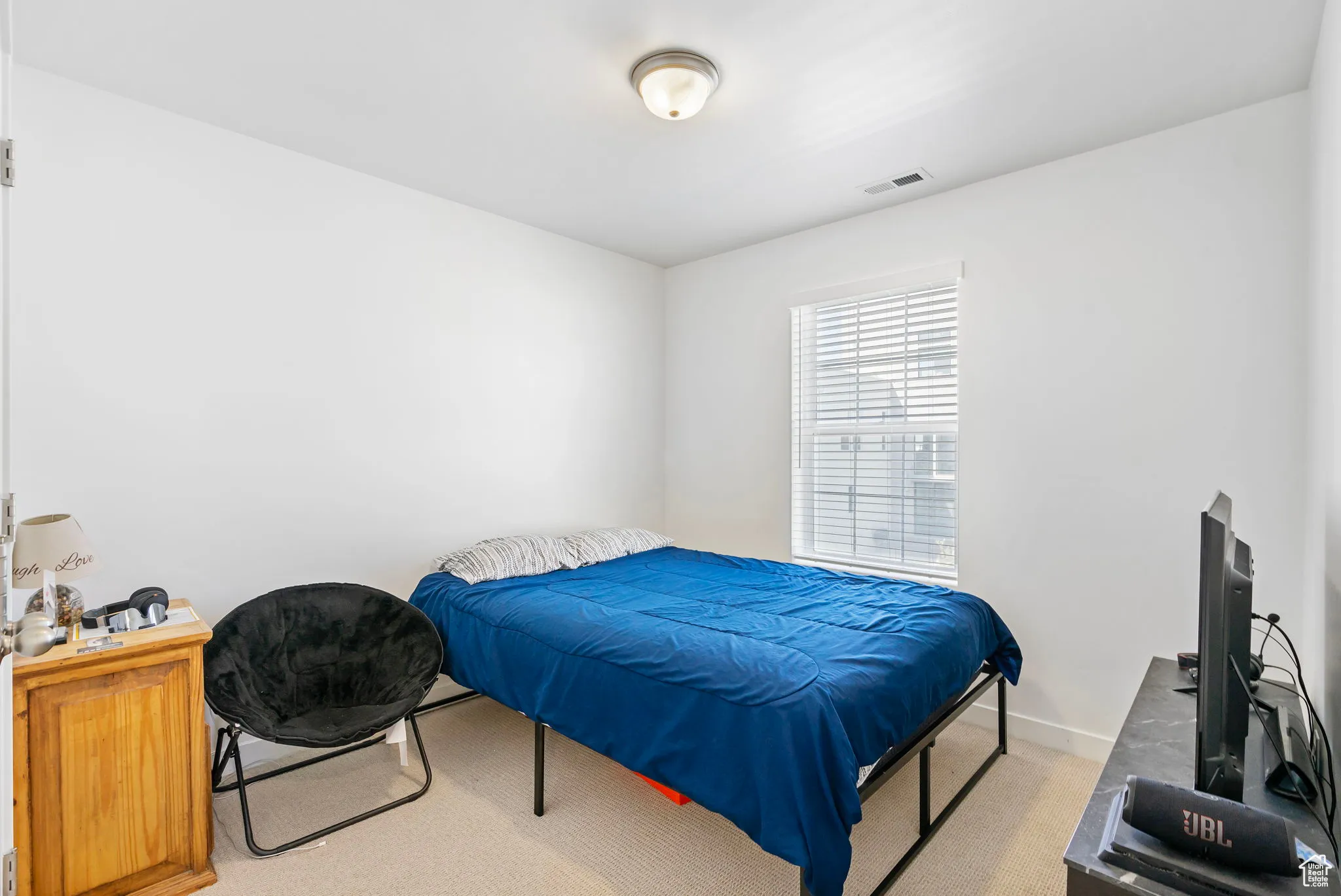 Bedroom featuring carpet floors and baseboards
