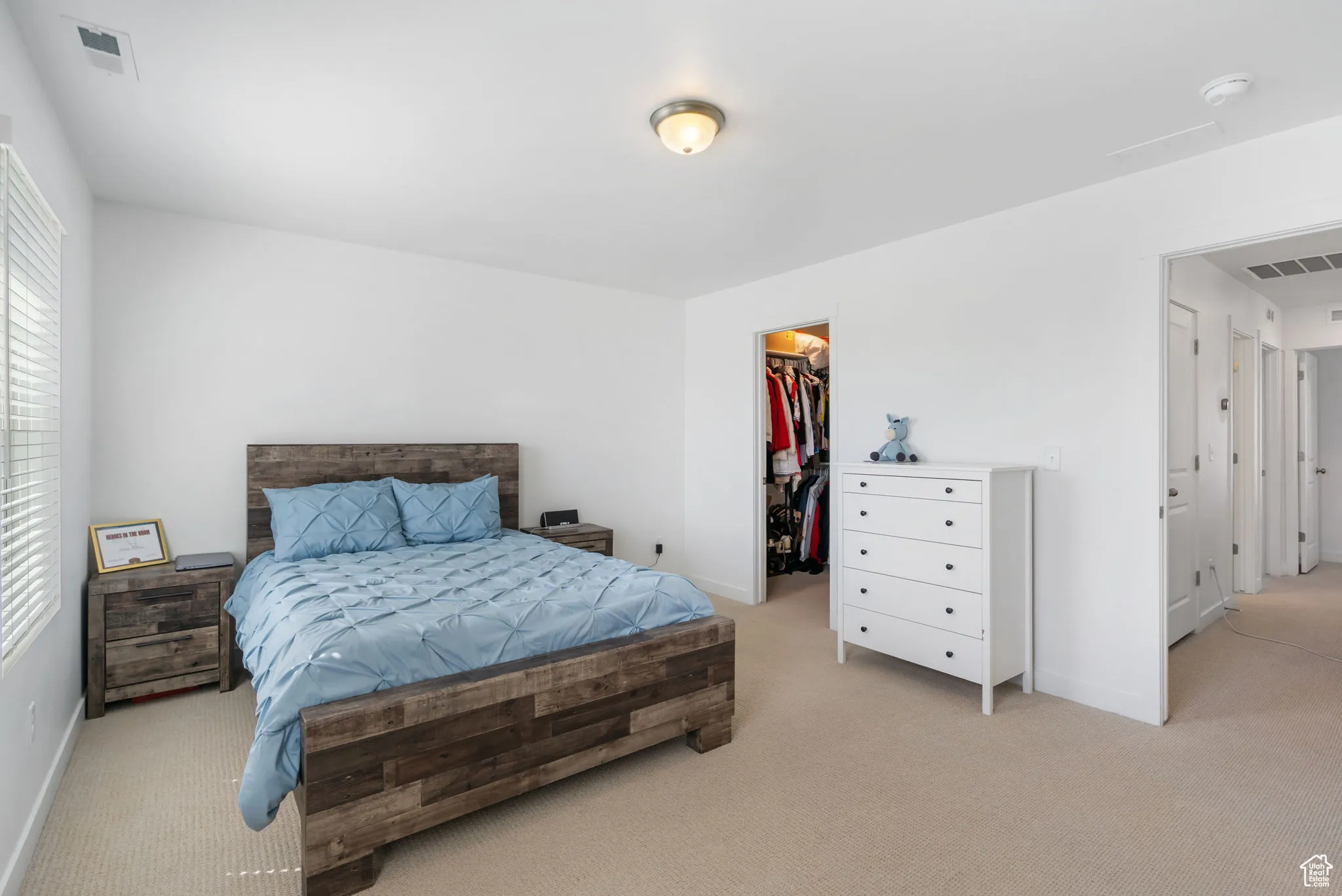 Bedroom featuring carpet flooring and a walk in closet