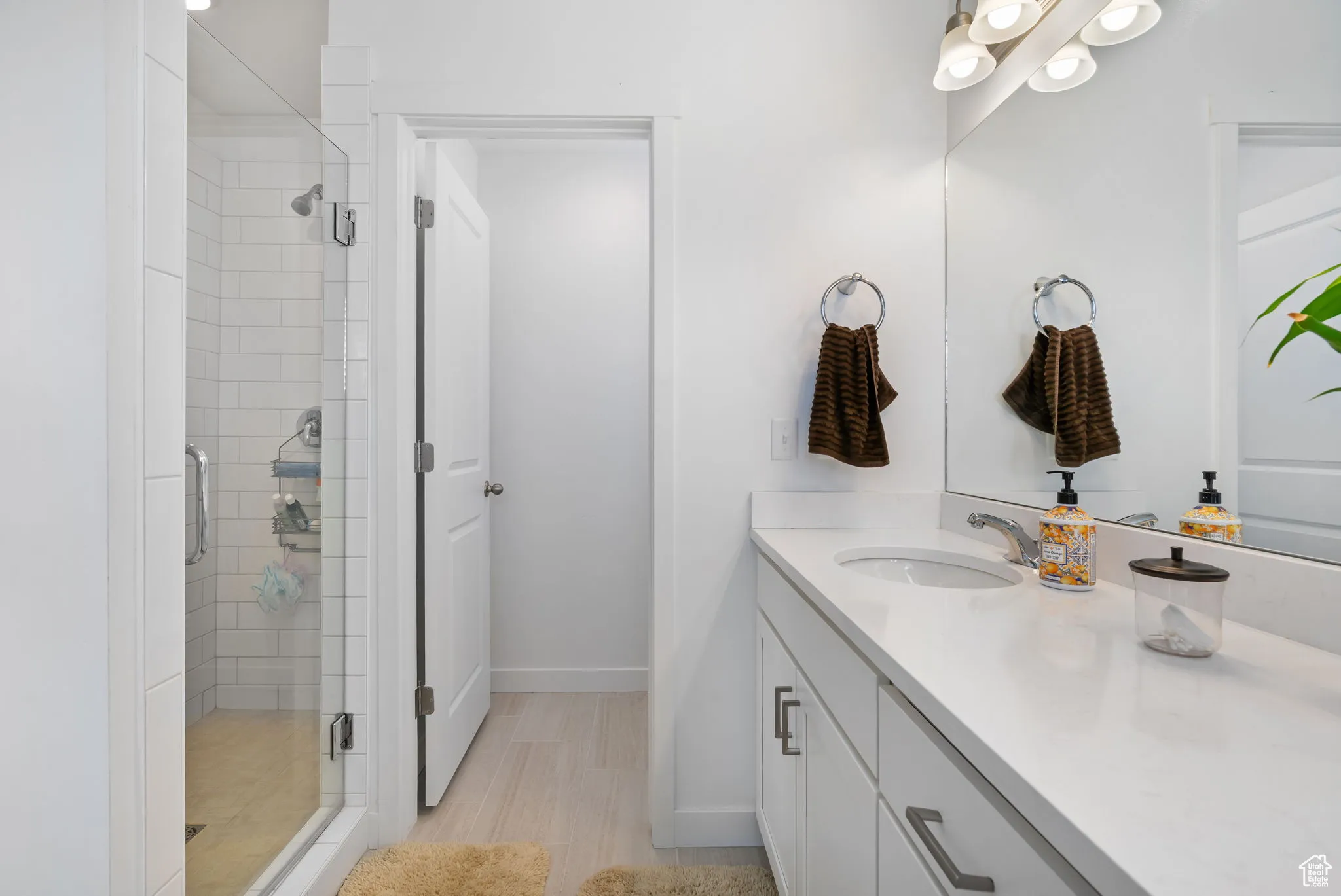 Full bathroom with a shower stall and vanity