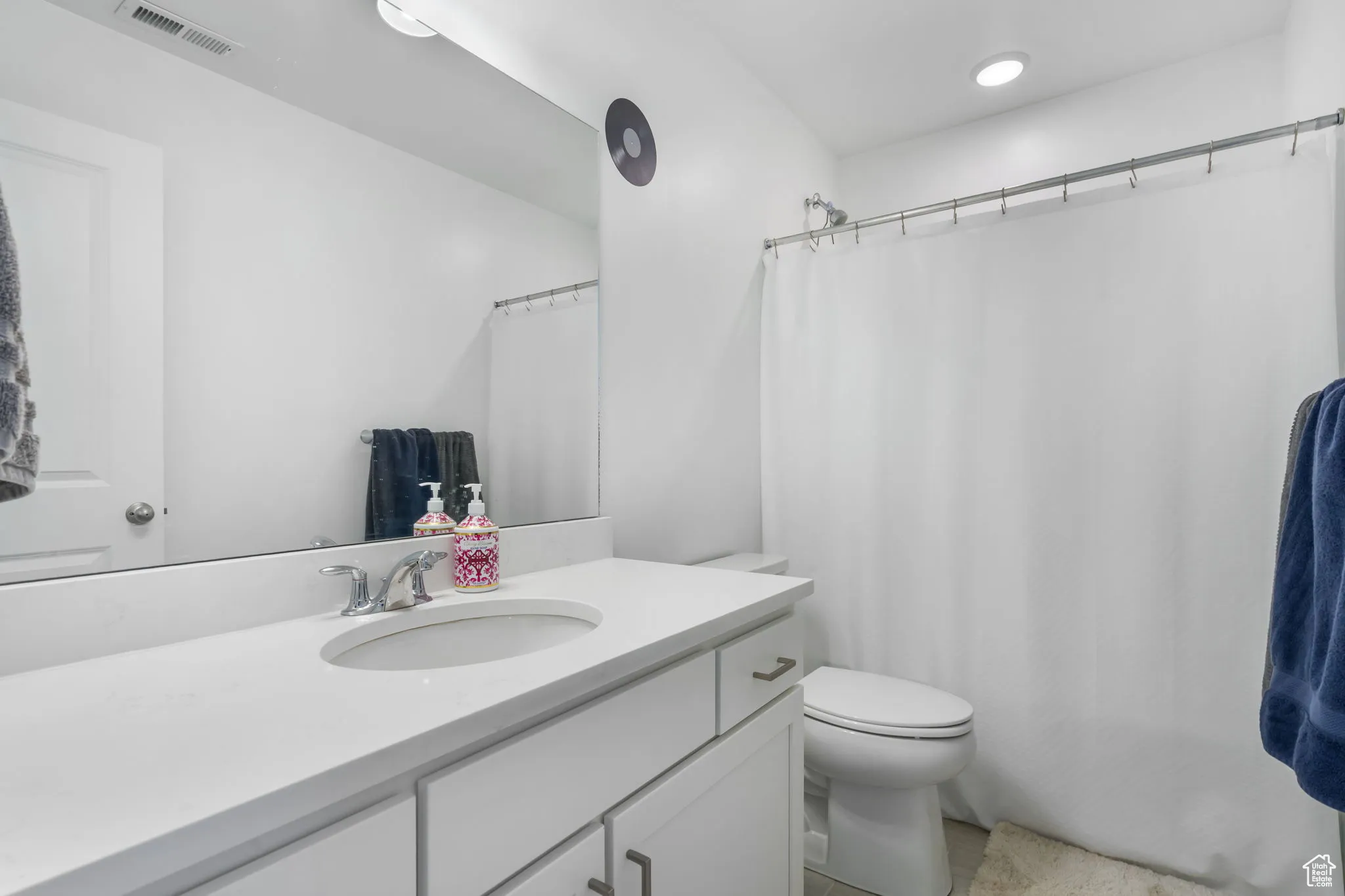 Bathroom with vanity and a shower with shower curtain