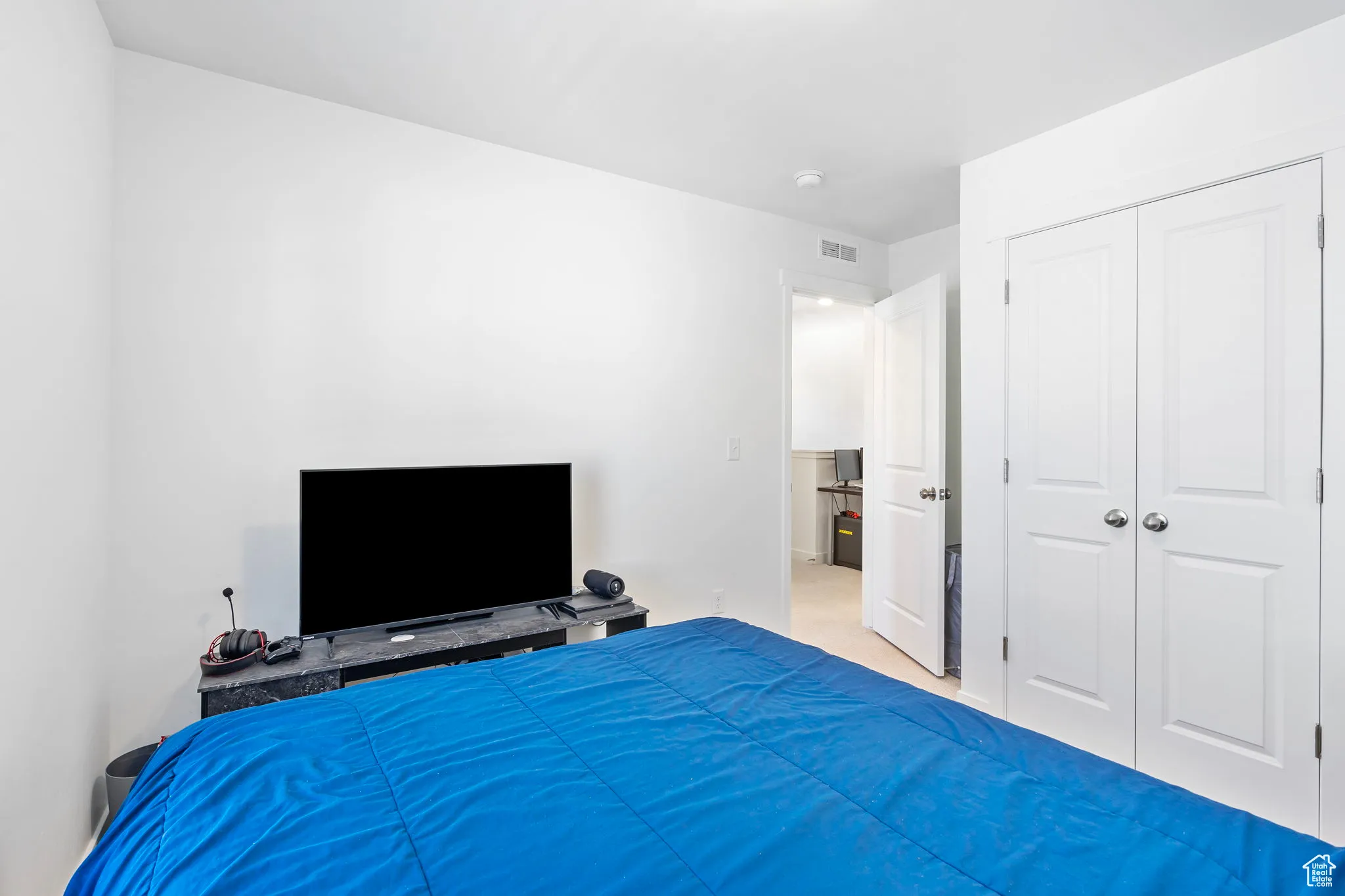 Bedroom featuring carpet floors and a closet