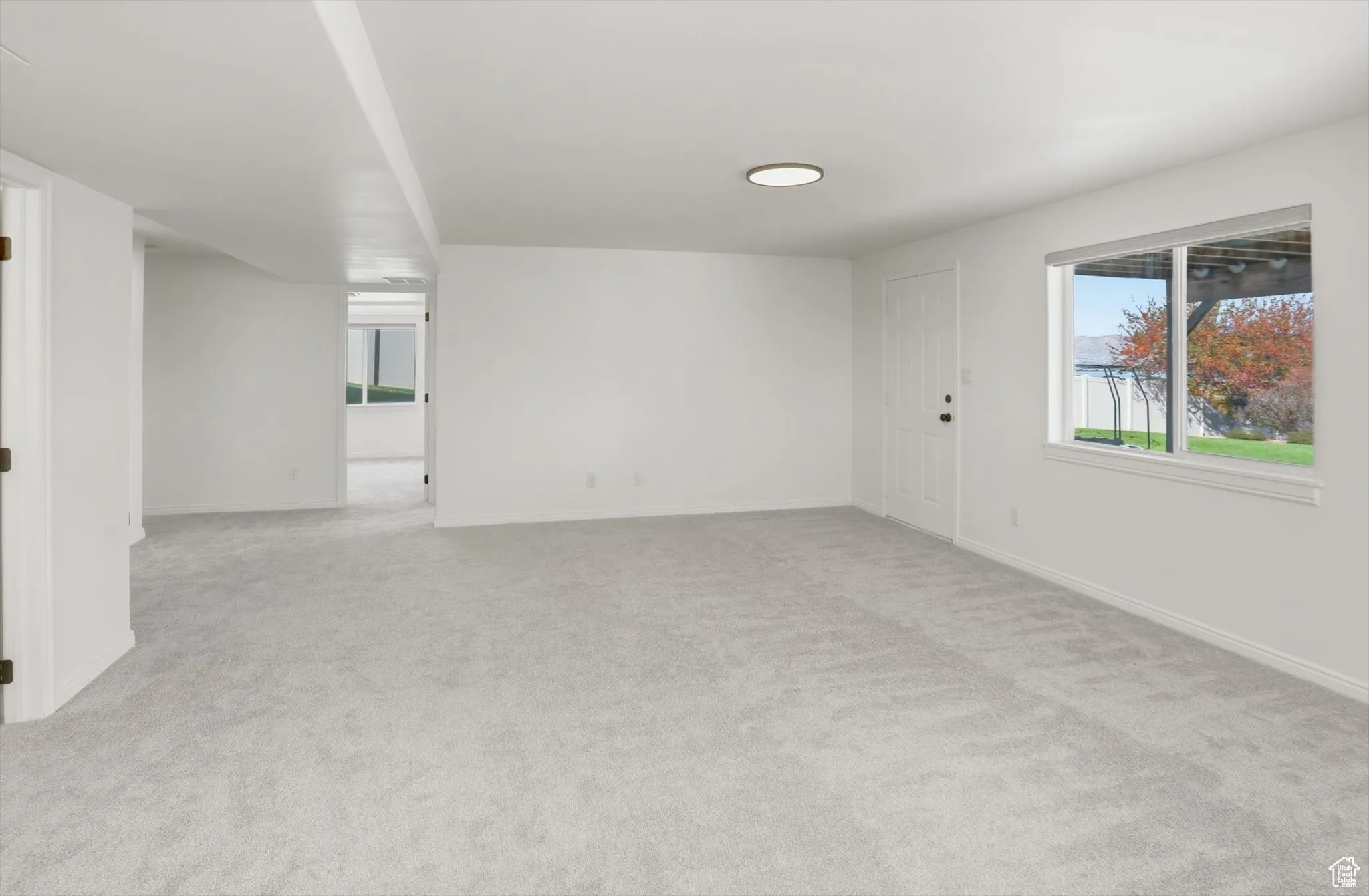 Unfurnished room with light colored carpet
