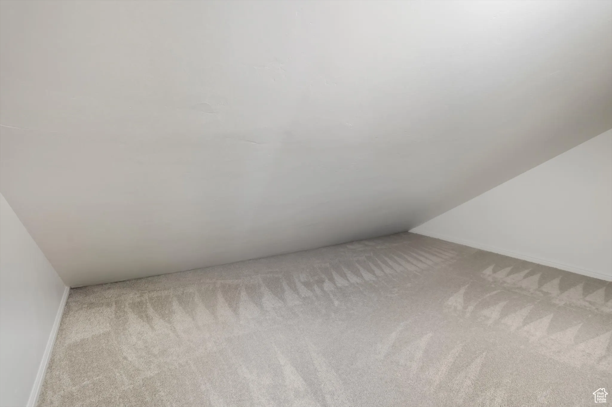 Detailed view of carpet flooring and baseboards