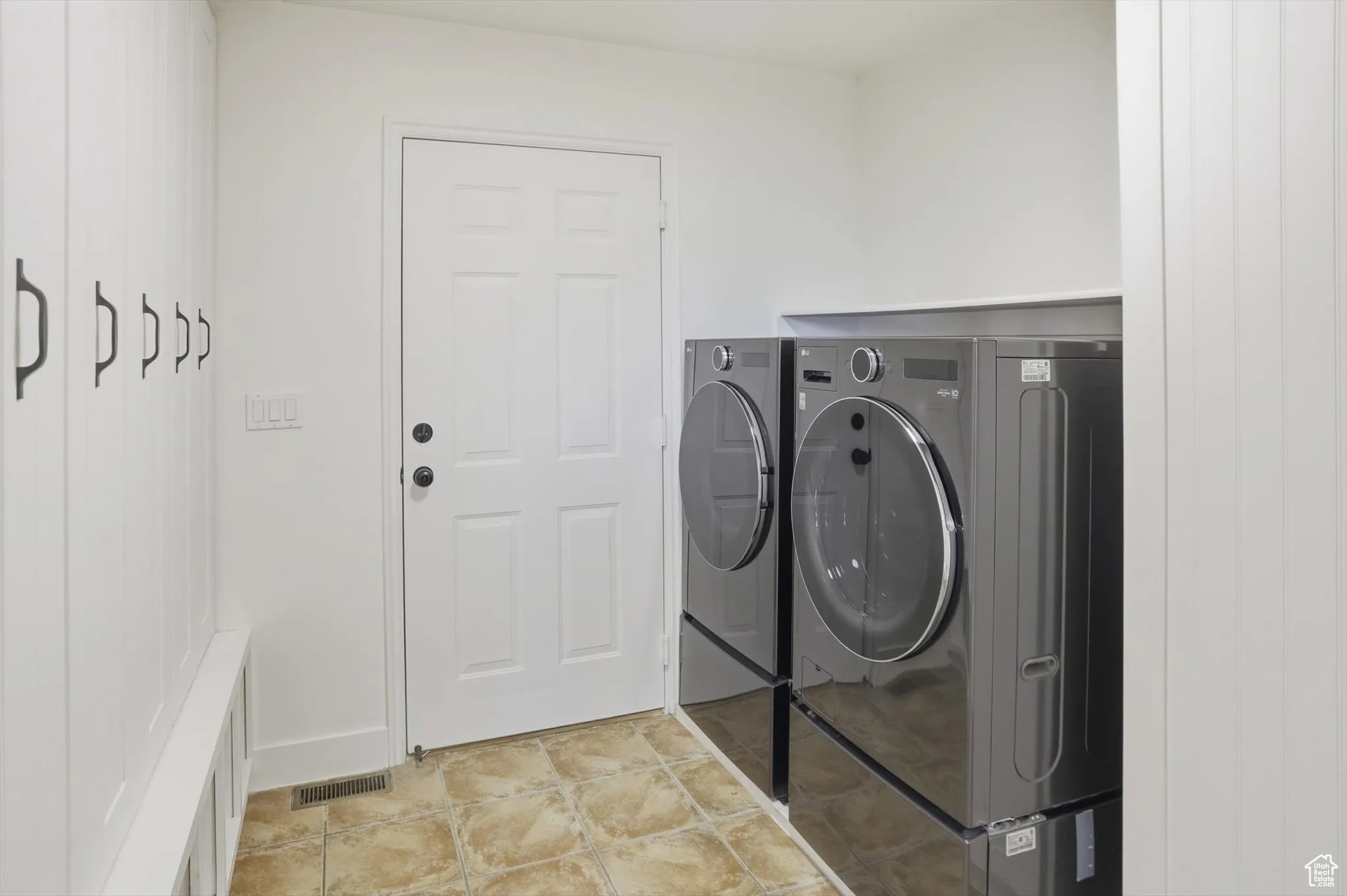 Laundry area with washer and dryer and baseboards