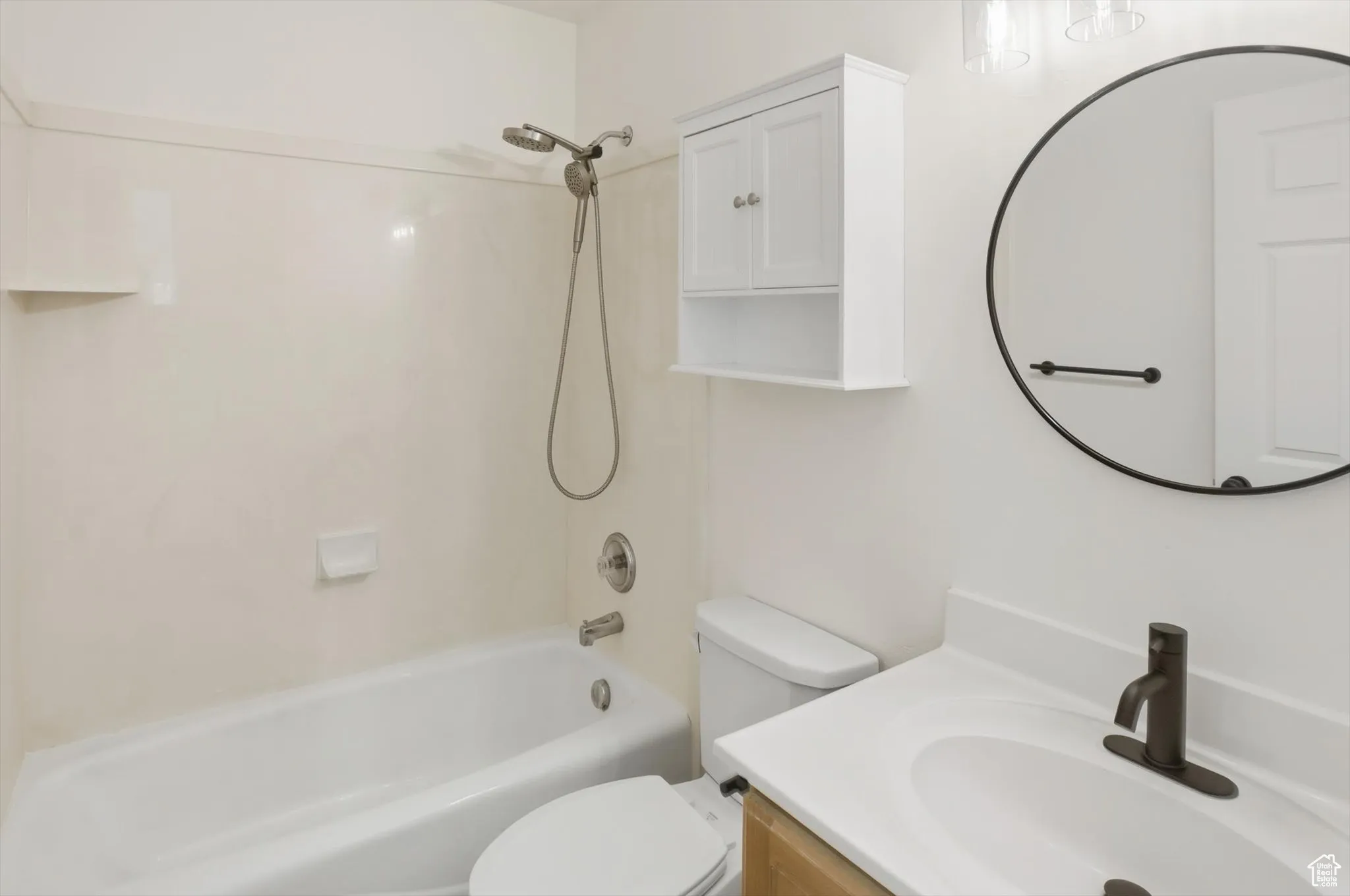 Full bath featuring vanity and bathing tub / shower combination