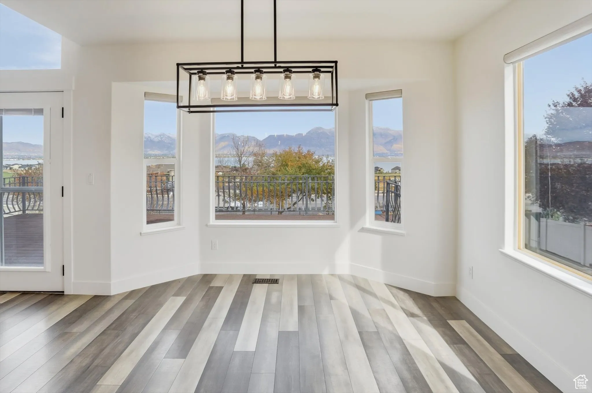 Unfurnished dining area with light wood-type flooring and baseboards