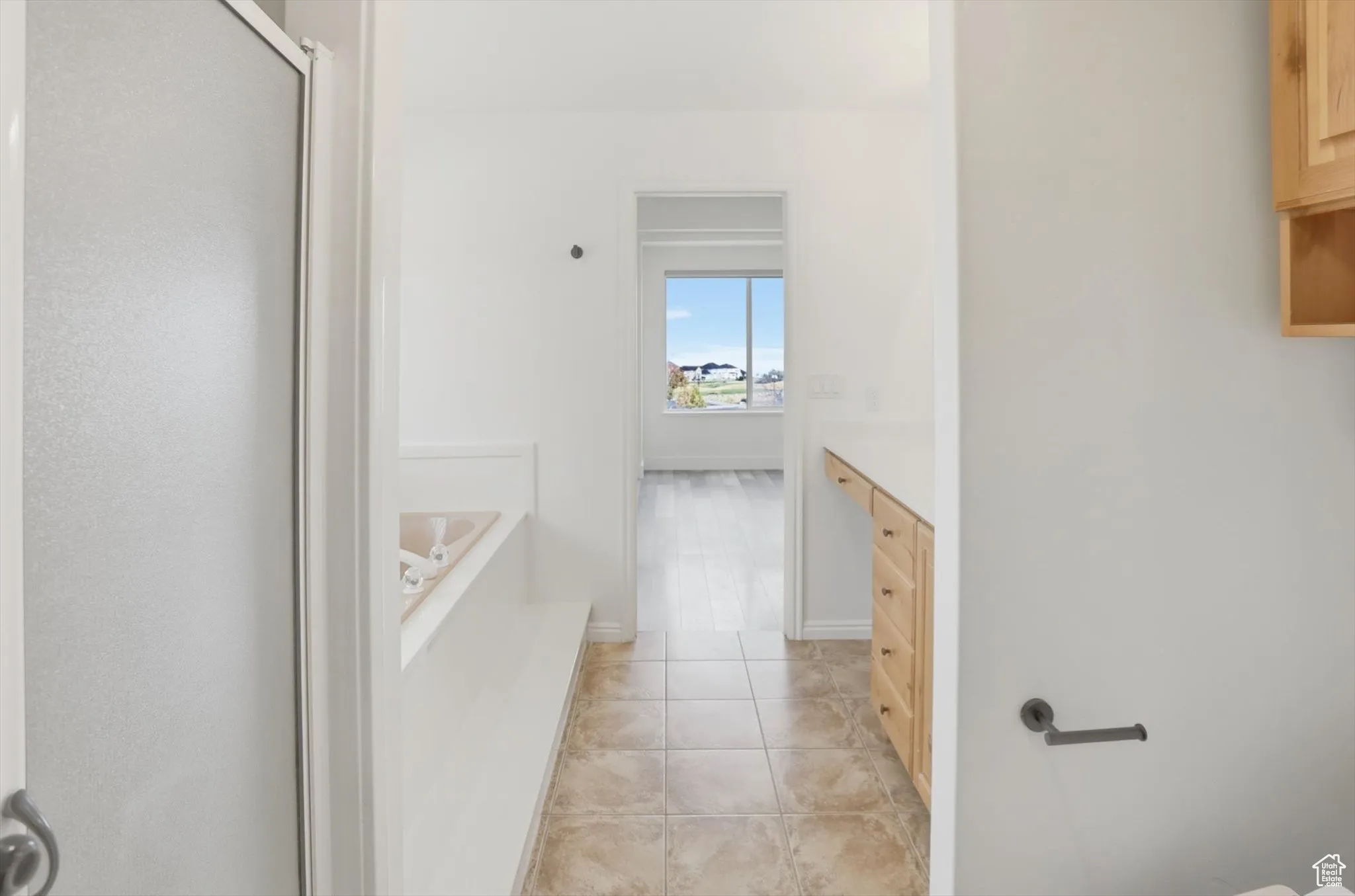 Full bathroom with light tile patterned flooring, a garden tub, vanity, and a shower stall