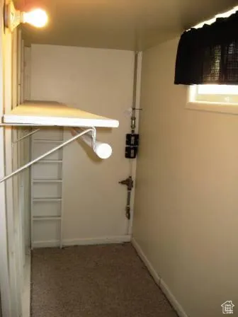 Walk in closet featuring dark carpet