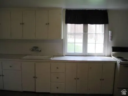 Kitchen with white range oven and light countertops