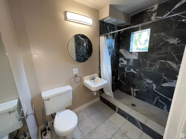 Full bathroom with a stall shower and tile patterned flooring