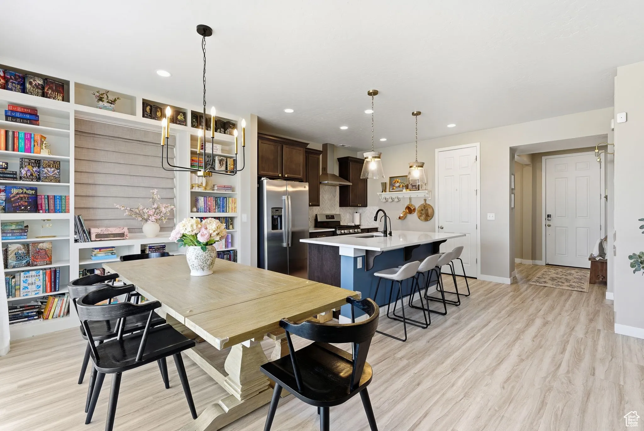 Dining space featuring light wood-style floors, recessed lighting, and a chandelier