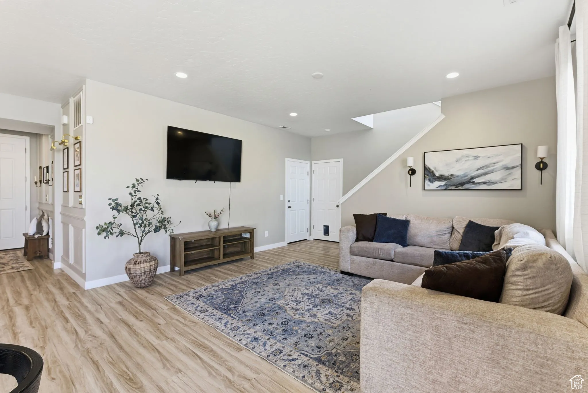 Living room featuring light wood-style floors and recessed lighting