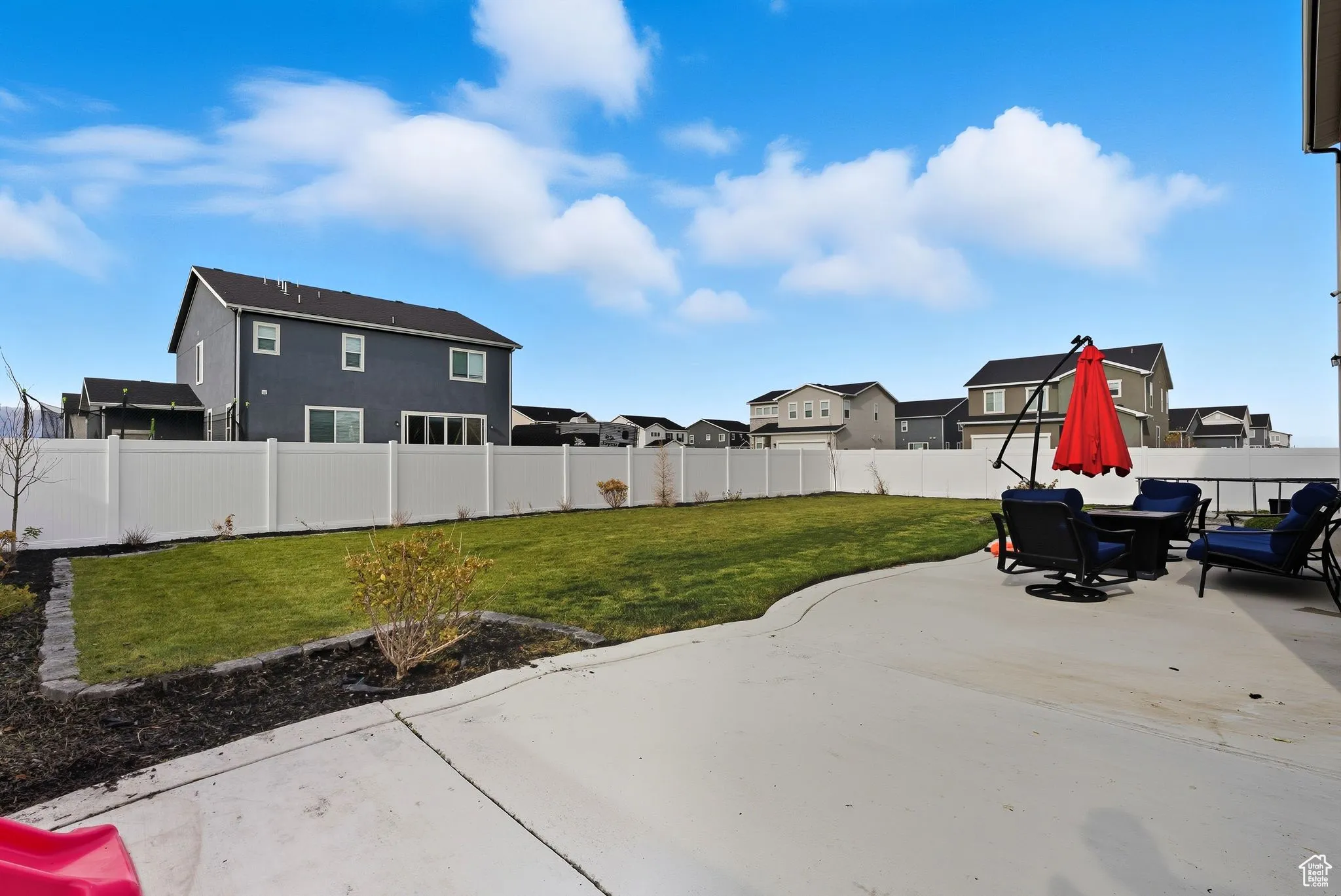 Fenced backyard featuring a patio area and a residential view