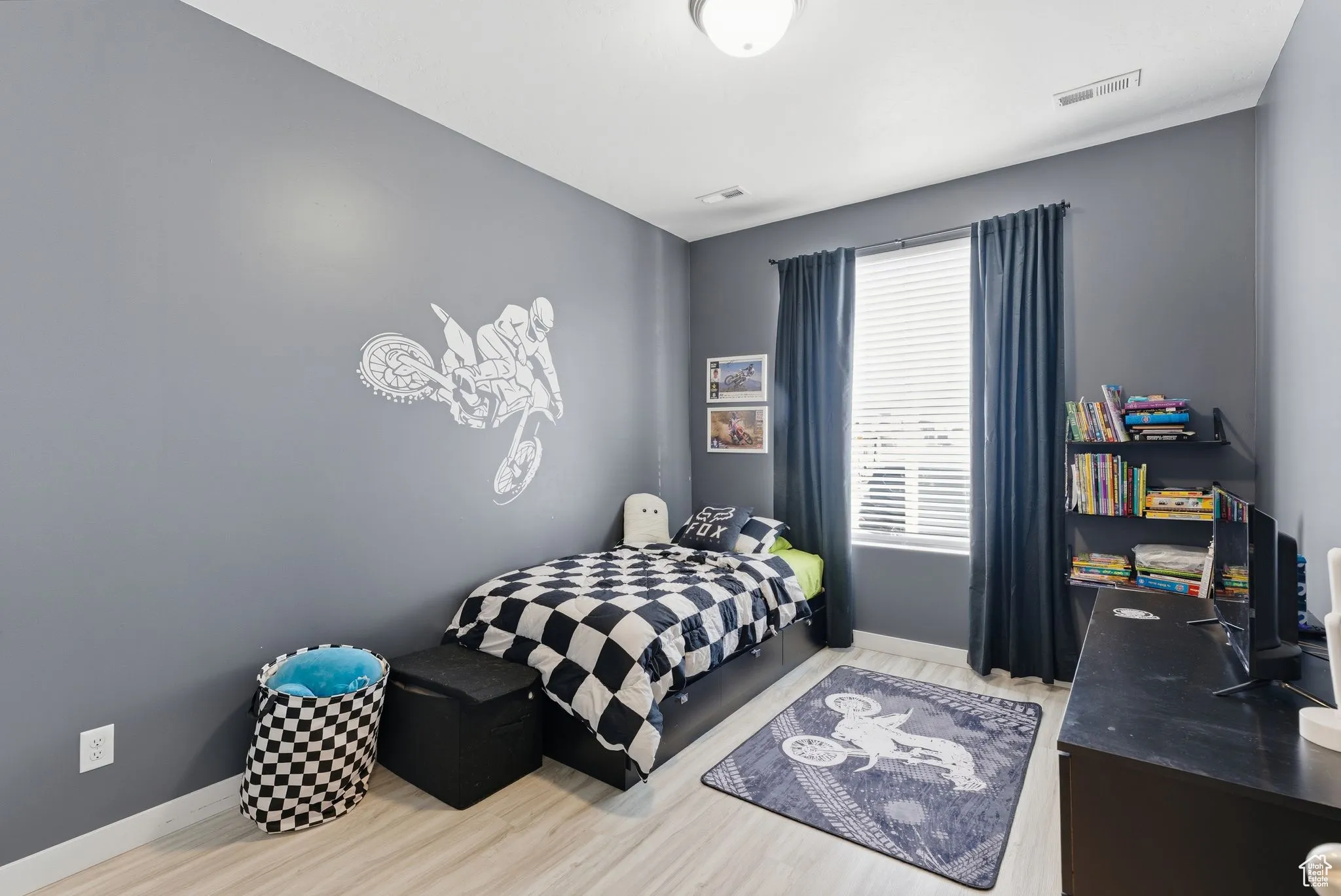 Bedroom featuring light wood-style flooring and baseboards