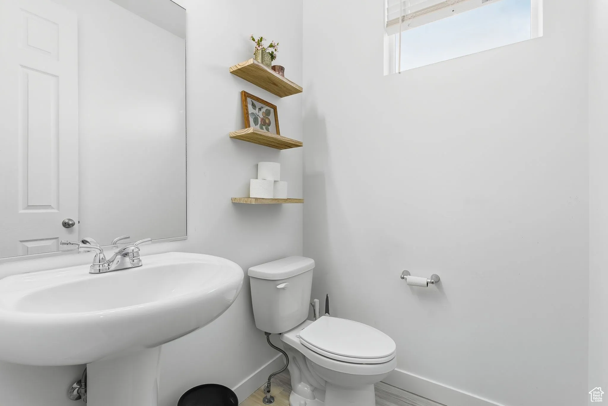 Half bathroom featuring baseboards and wood finished floors
