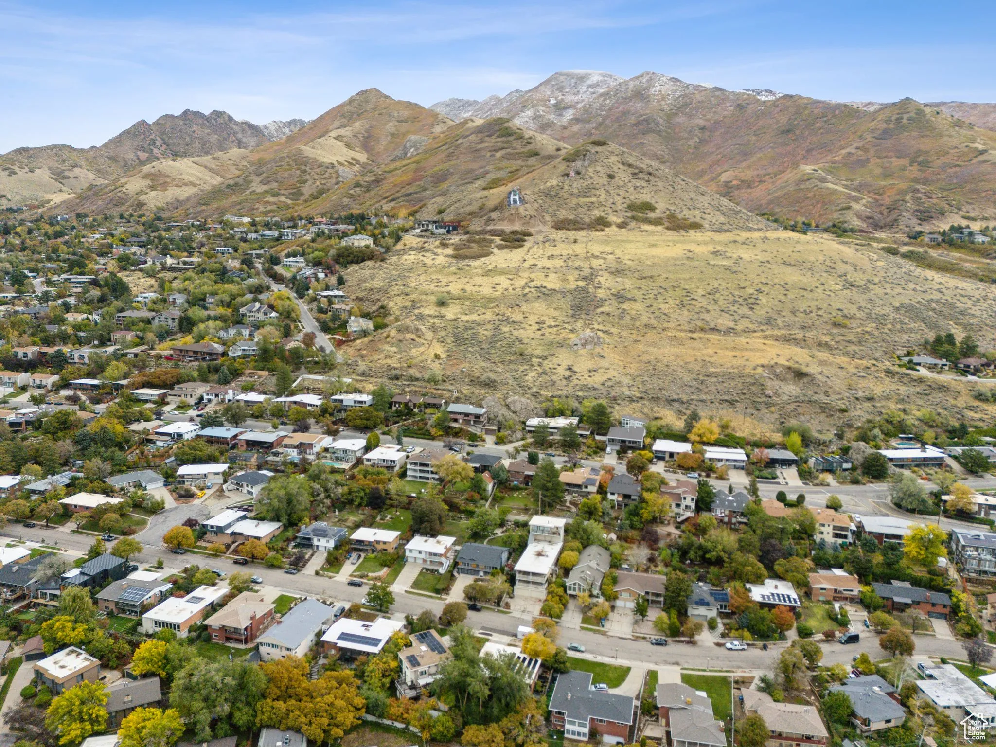 Aerial view of property's location with mountains and nearby suburban area
