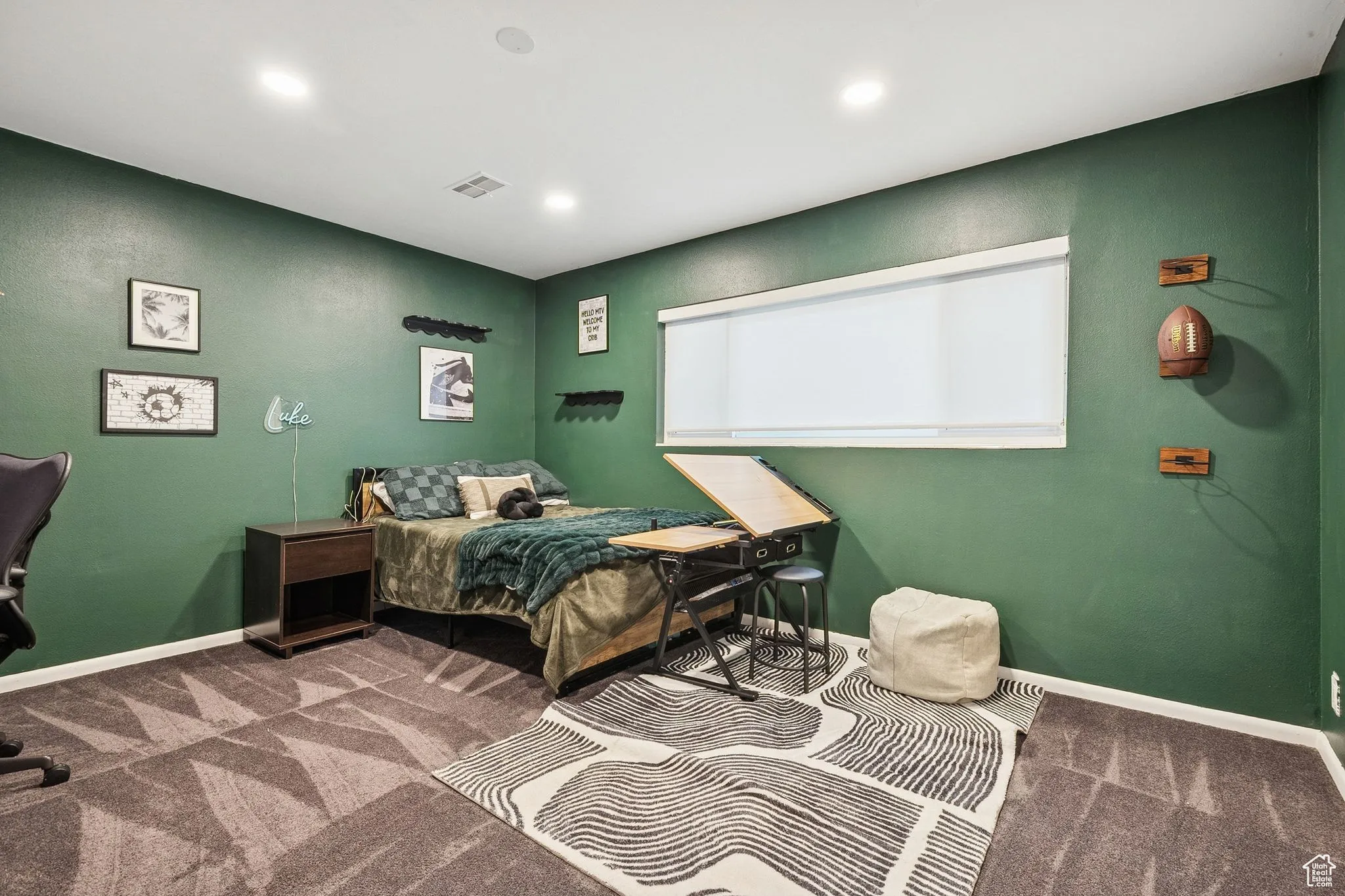 Bedroom with dark colored carpet and recessed lighting