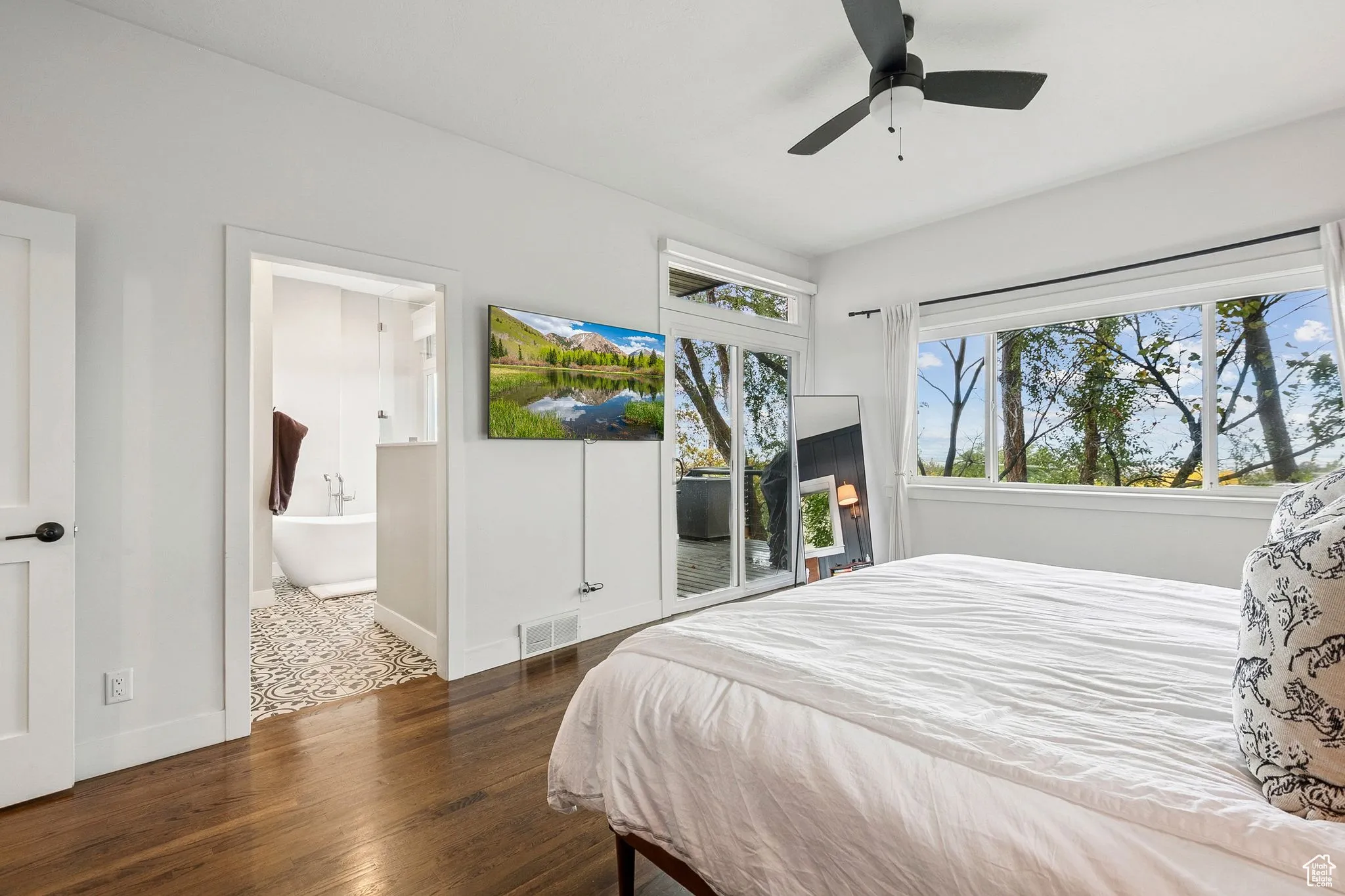 Bedroom with access to outside, dark wood-style flooring, a ceiling fan, and ensuite bathroom