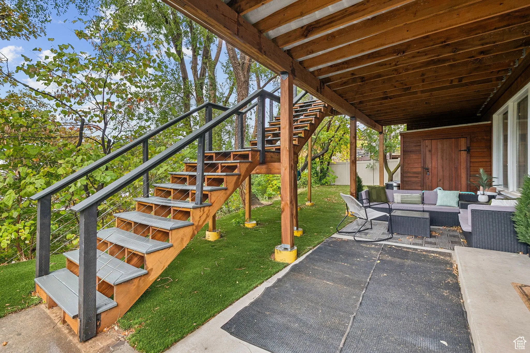 View of patio with stairs and an outdoor living space