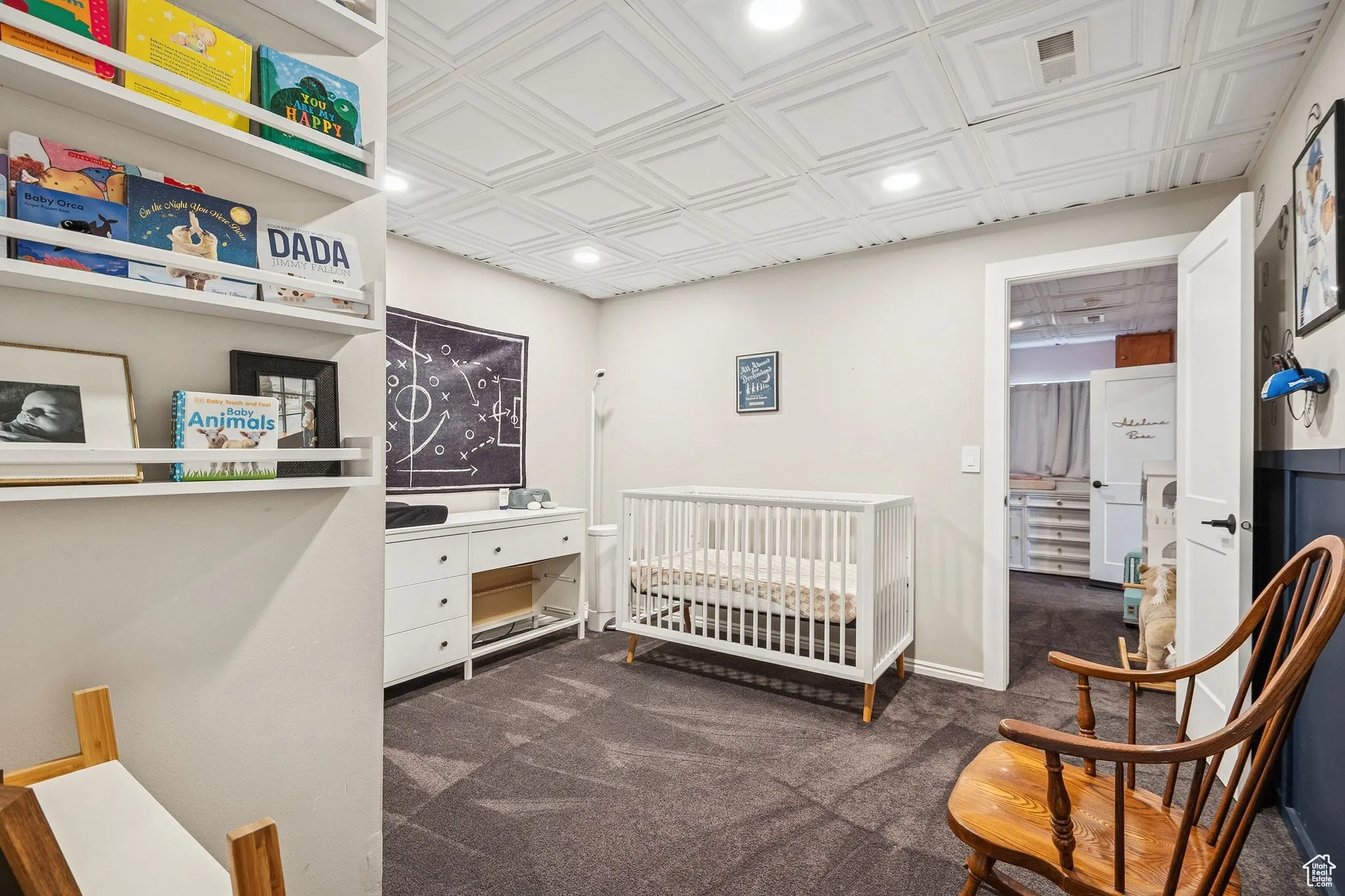 Bedroom with dark colored carpet, an ornate ceiling, a nursery area, and recessed lighting