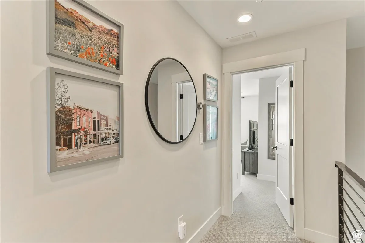 Third floor hallway leading to primary bedroom