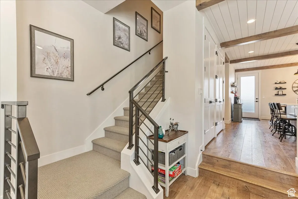 Stairs leading to third level, door to back patio