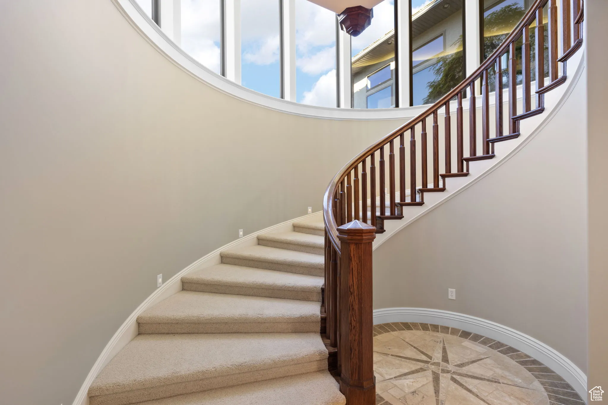 Large spiral staircase leads to lower level