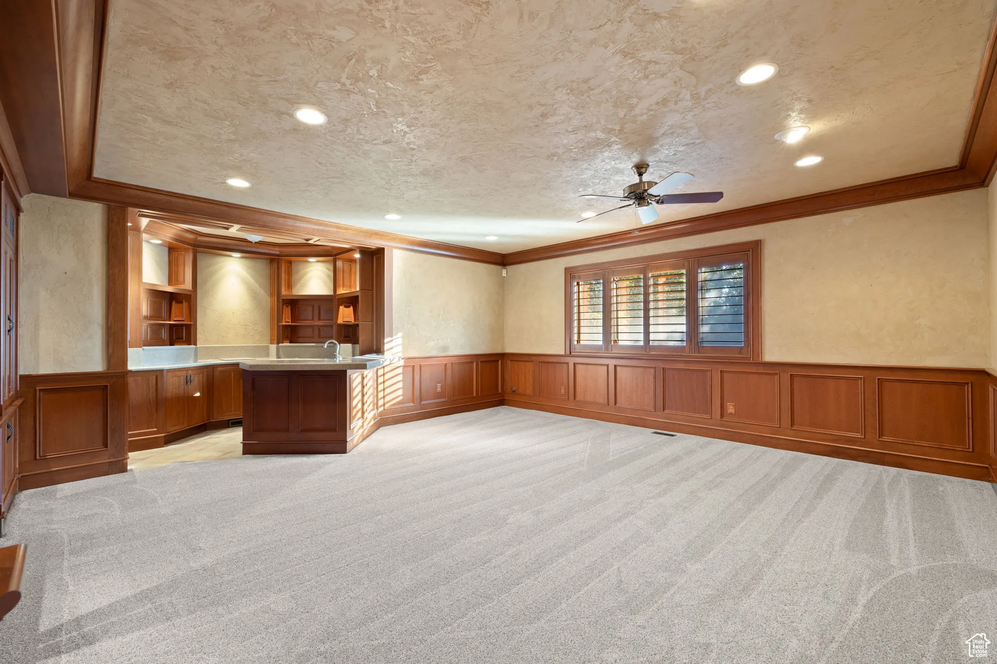 Den with beautiful wood paneling and wet bar