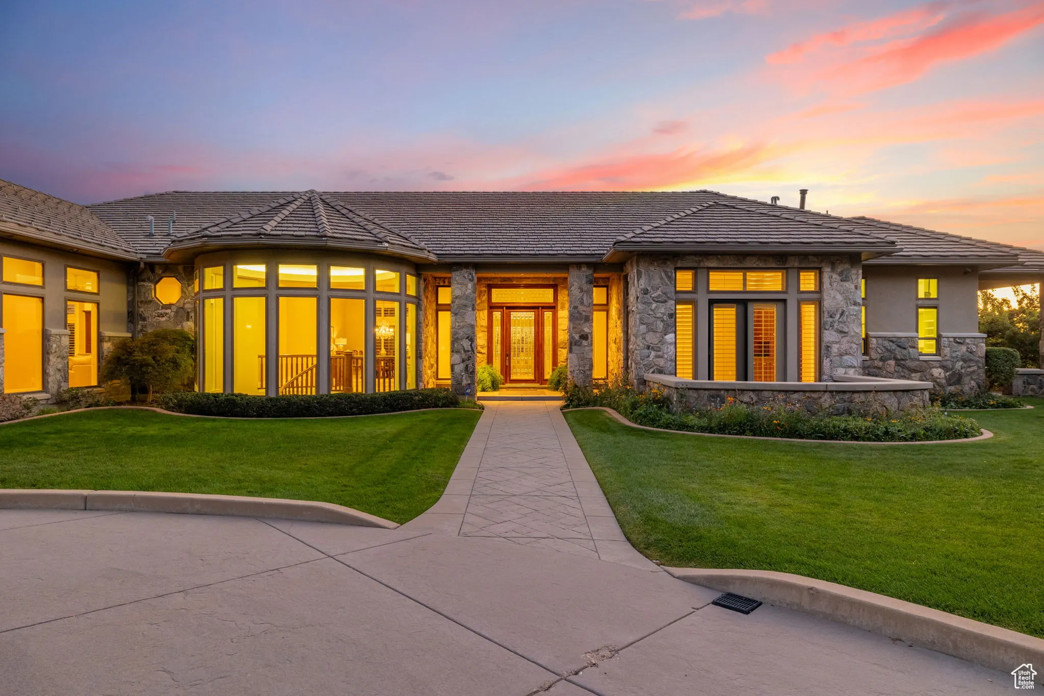 Split granite and stucco exterior with tile roof