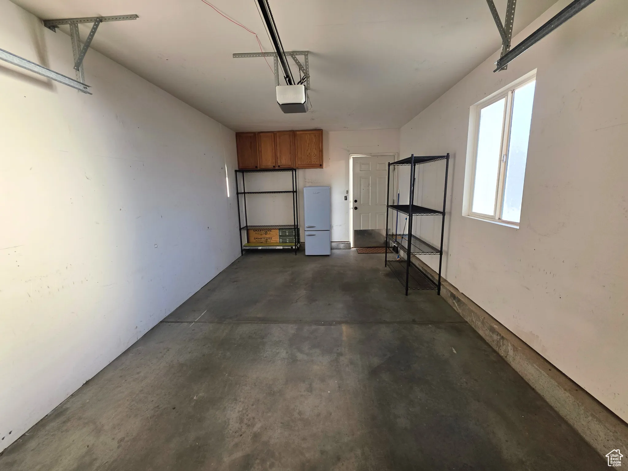 Garage featuring a garage door opener
