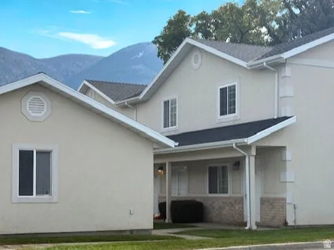 View of front of home with stucco siding and a mountain view