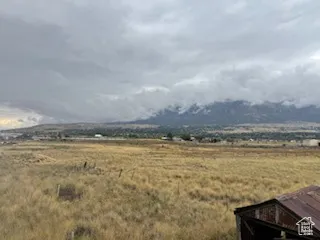View of mountain backdrop with rural landscape