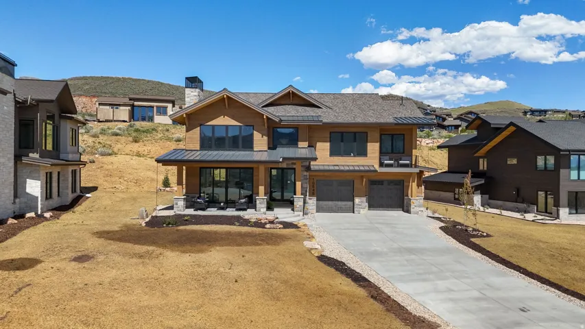 Contemporary residence featuring a wood-panel and stone facade