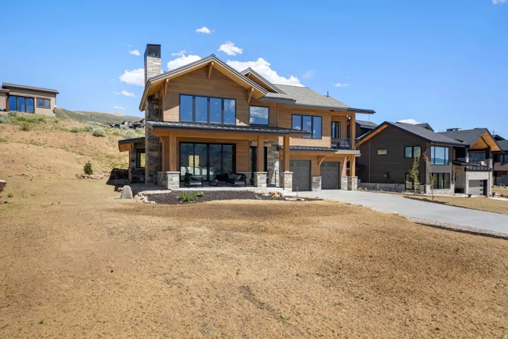 Contemporary residence featuring a multi-level design with stone and wood siding