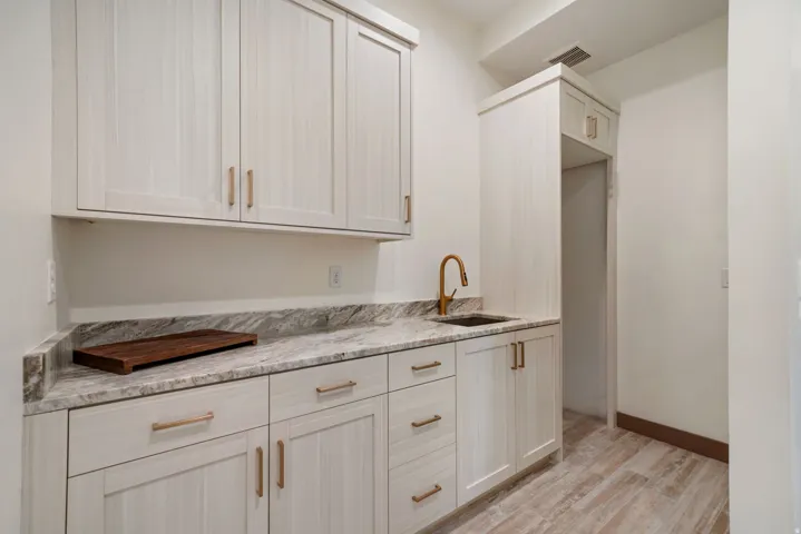 Cabinetry with a light wood-grain finish and gold-tone hardware