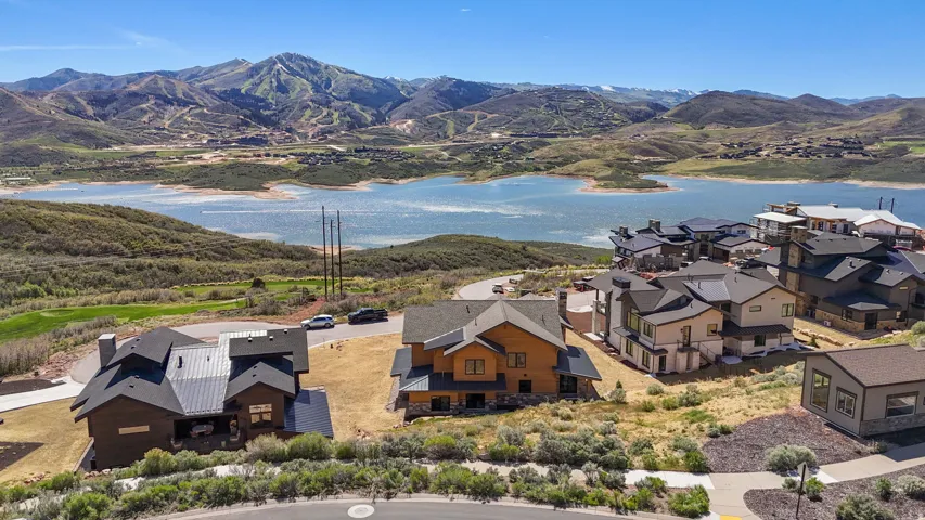 Lakefront properties featuring contemporary architecture and natural wood and stone facades