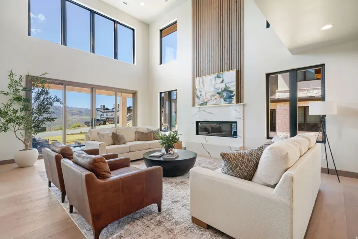 Spacious living area featuring a vaulted ceiling and wood-finish flooring