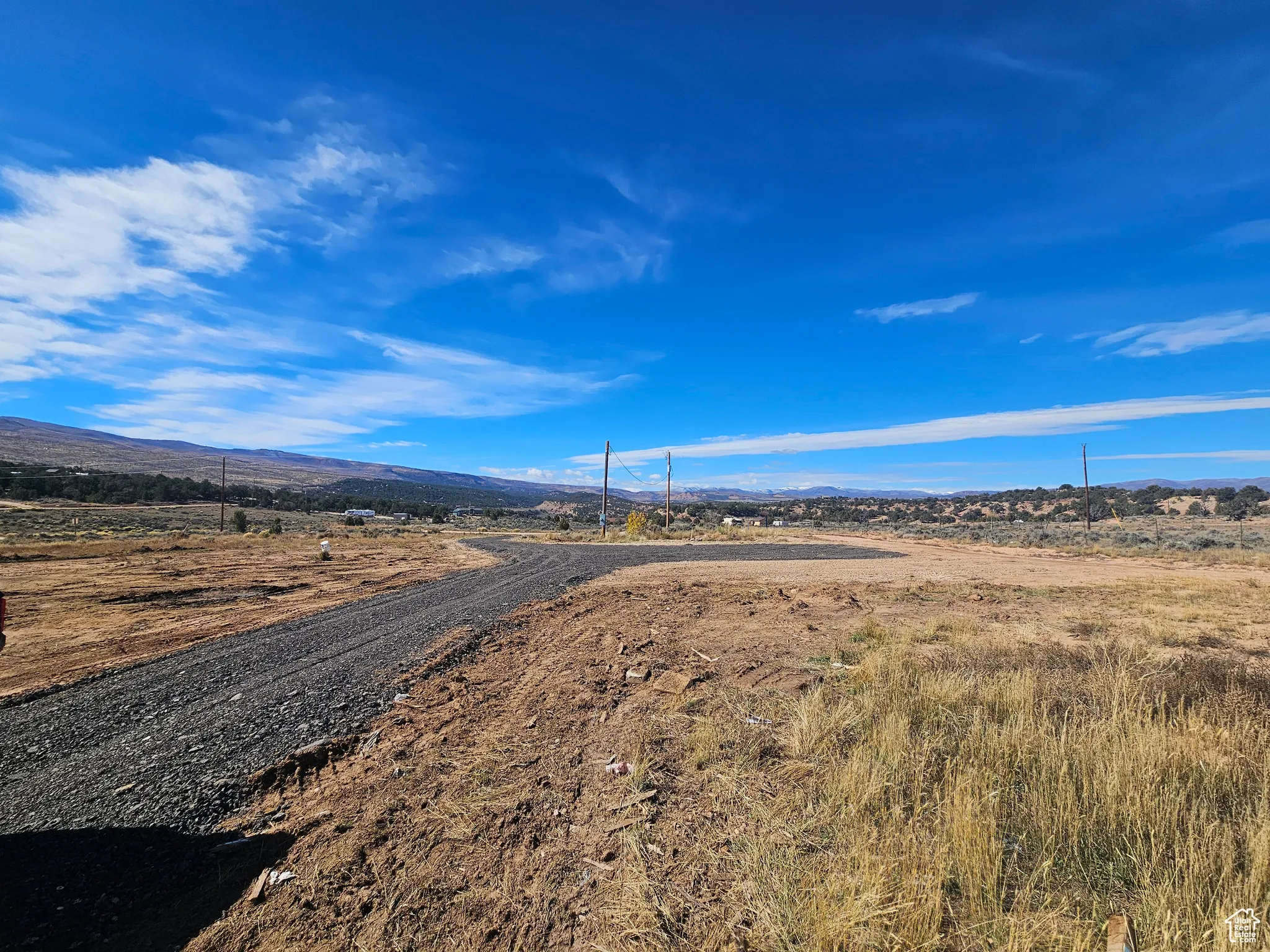 View of gravel driveway with a mountain view and a rural view