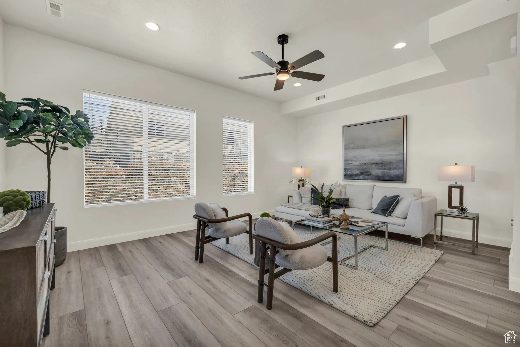 Living room with recessed lighting, light wood-style floors, and ceiling fan
