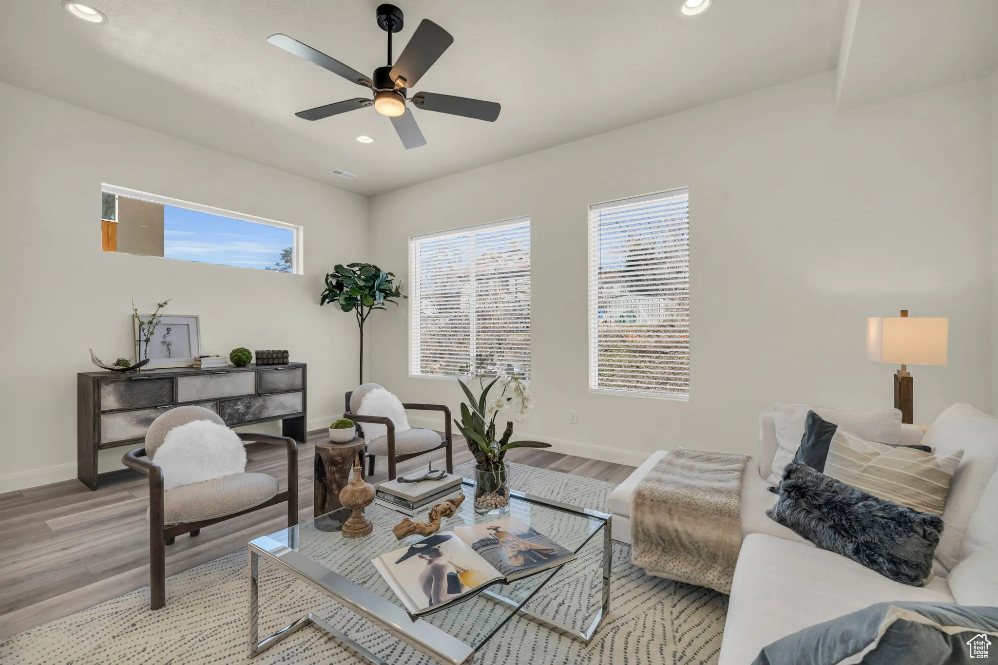 Living room with healthy amount of natural light, recessed lighting, wood finished floors, and ceiling fan