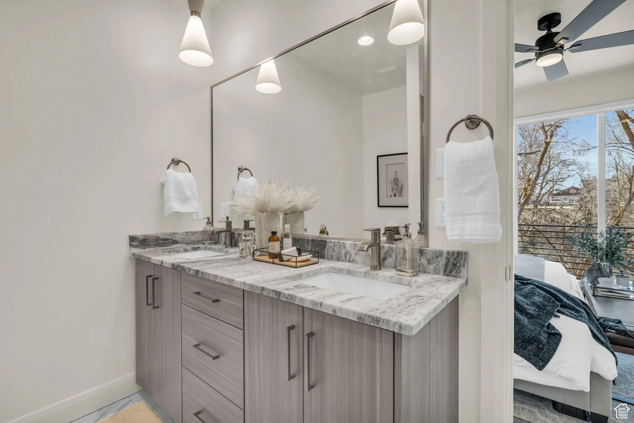 Ensuite bathroom with double vanity and ceiling fan