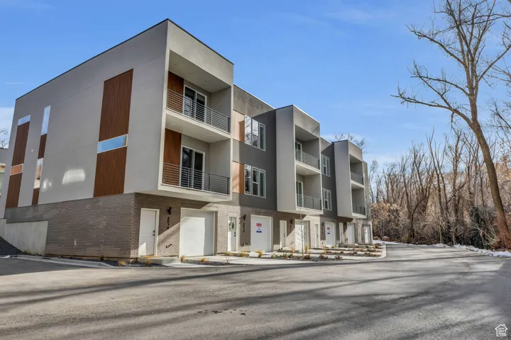 View of building exterior with an attached garage