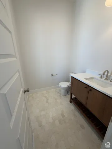 Half bathroom with vanity and toilet