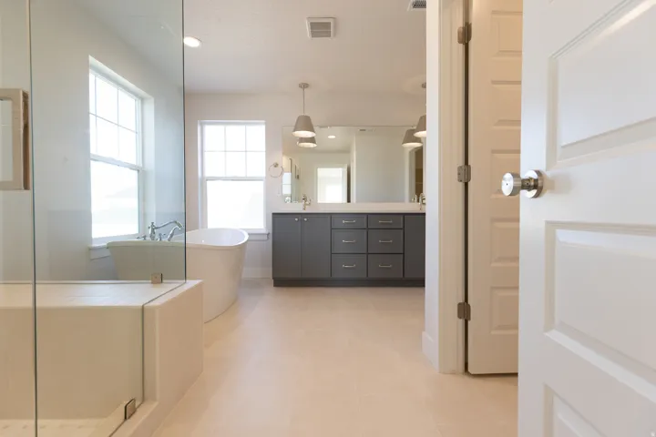 Full bath featuring double vanity, a soaking tub, healthy amount of natural light, recessed lighting, and a shower stall
